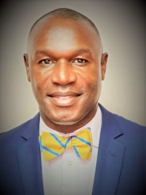 Man in suit with colorful bow tie.