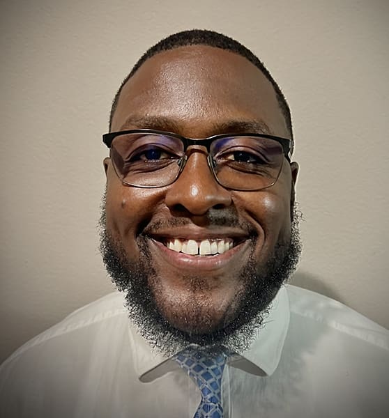 Smiling man with glasses and beard.