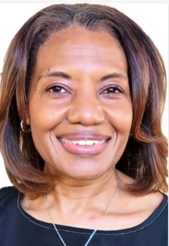 Smiling woman with shoulder-length brown hair.