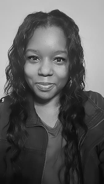 Smiling person in black and white portrait.
