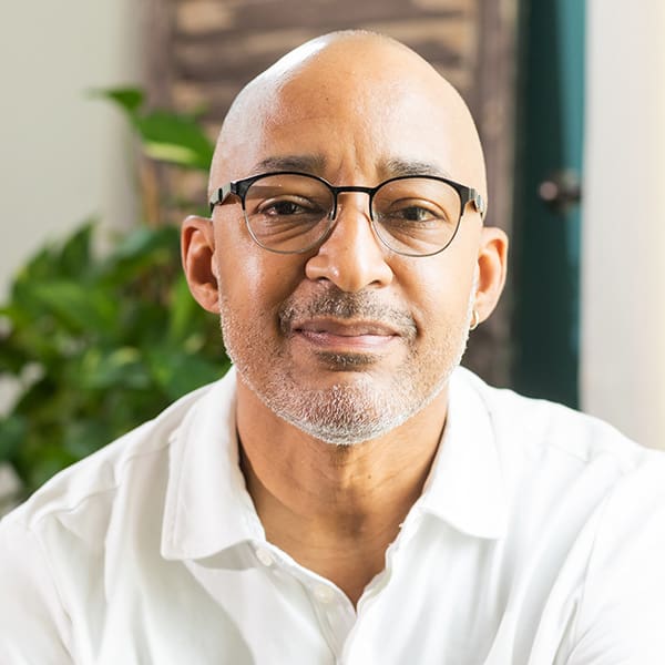 Man in glasses with a white shirt.
