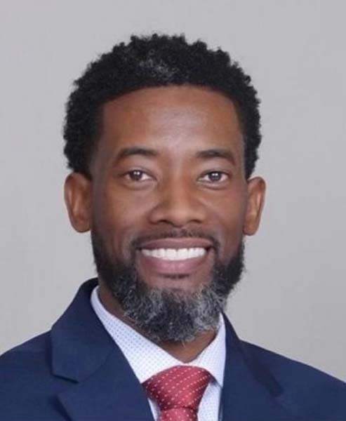 Smiling man in a suit and tie.